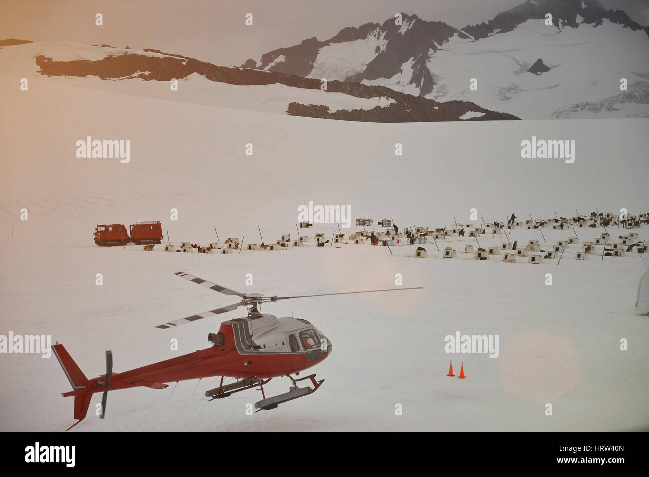 Helicopter winter tour in mountains. Dog sledding base in Alaska mounatins. Travel activity in Alaskan glacier Stock Photo