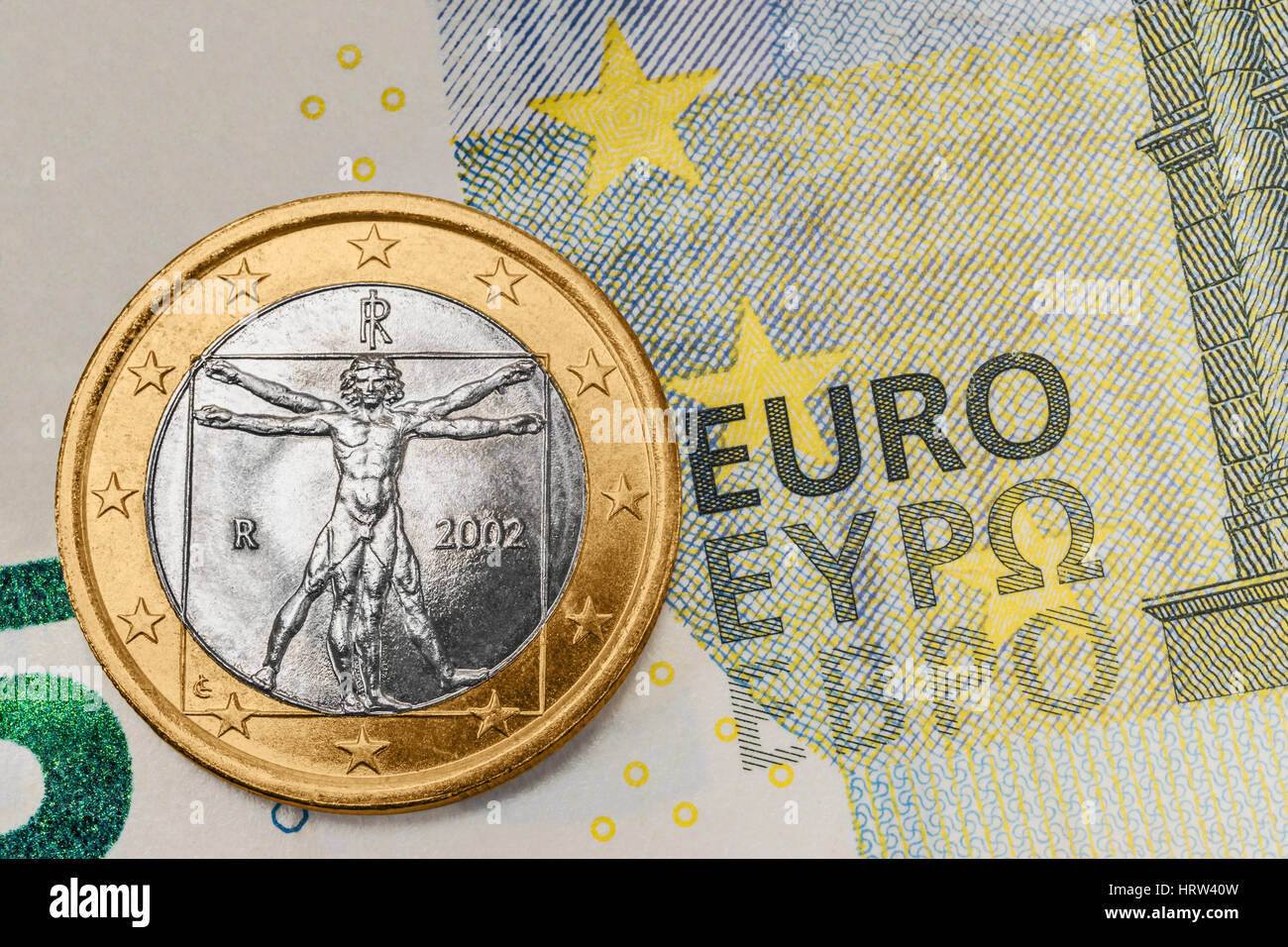 a 1 euro coin from Italy on a 5 euro banknote Stock Photo