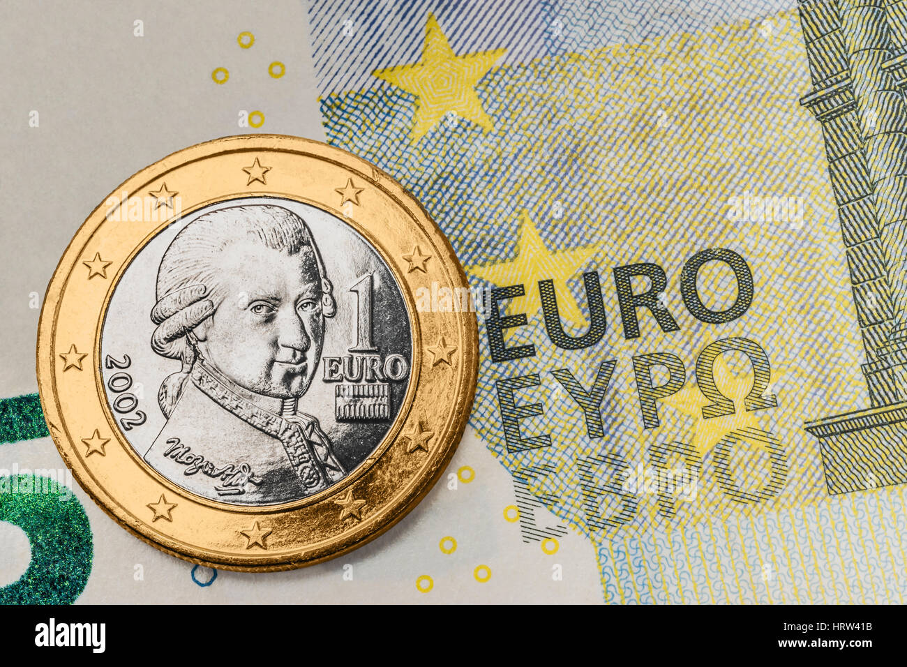 a 1 euro coin from Austria on a 5 euro banknote Stock Photo