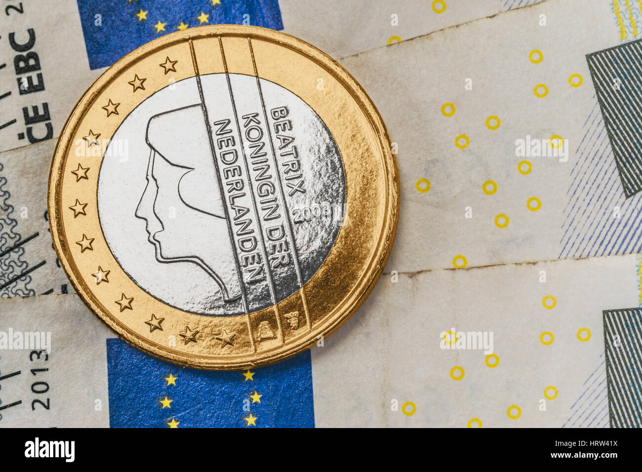 a 1 euro coin from the Netherlands on euro banknotes Stock Photo
