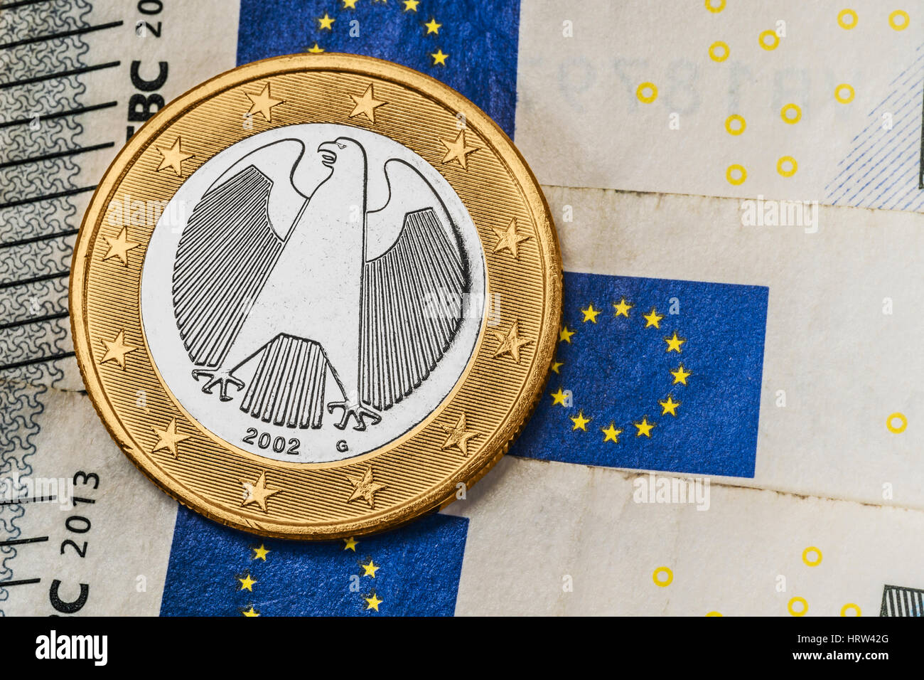 a 1 euro coin from Germany on euro banknotes Stock Photo