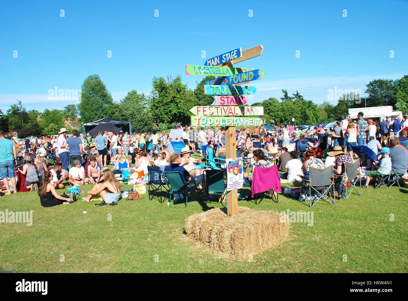 The audience sit on the grass at the annual Tentertainment music festival at Tenterden in Kent, England on July 4, 2015. Stock Photo