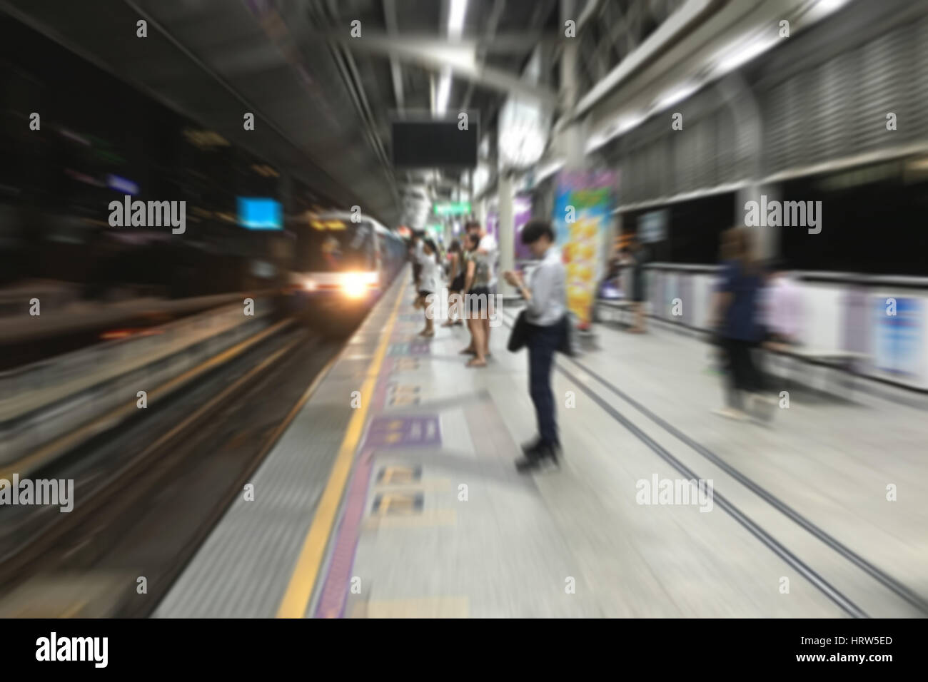 Abstract camera zoom of people waiting the electric train at night. Stock Photo