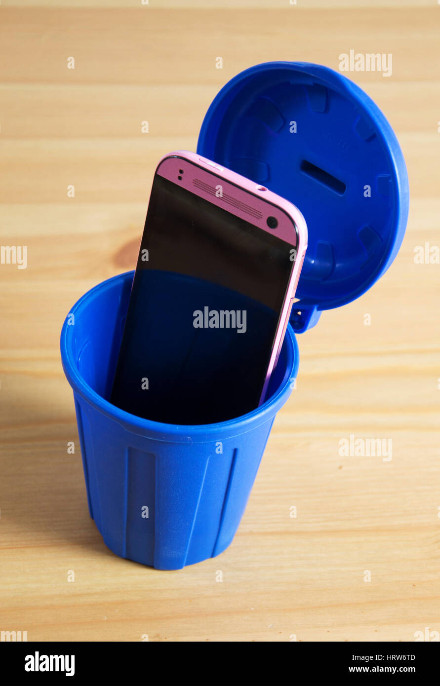 a mobile phone in a trash can Stock Photo Alamy