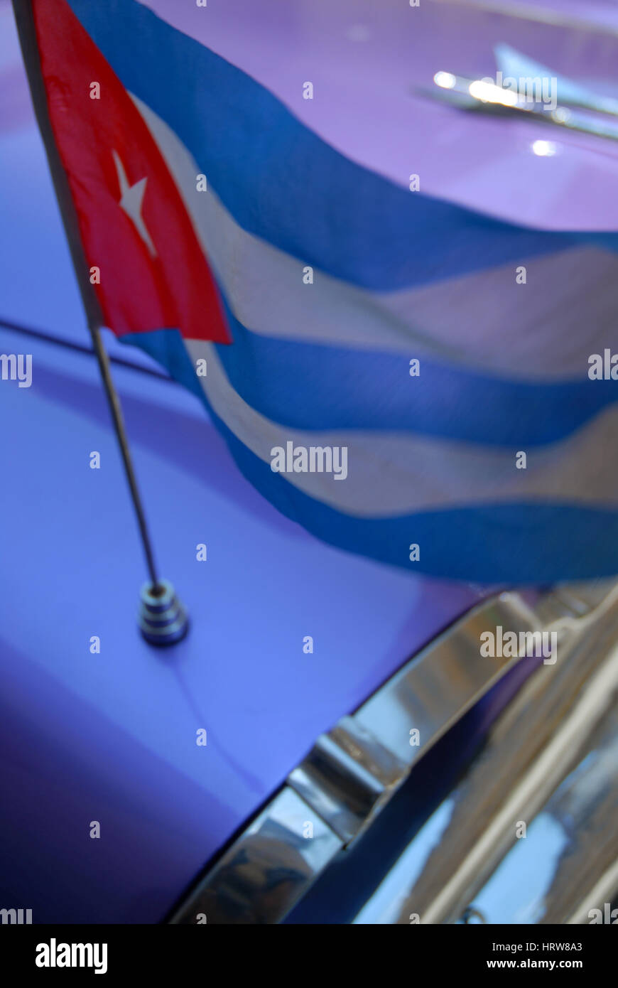 of purple vintage car with Cuban Flag, Parque Central, Havana