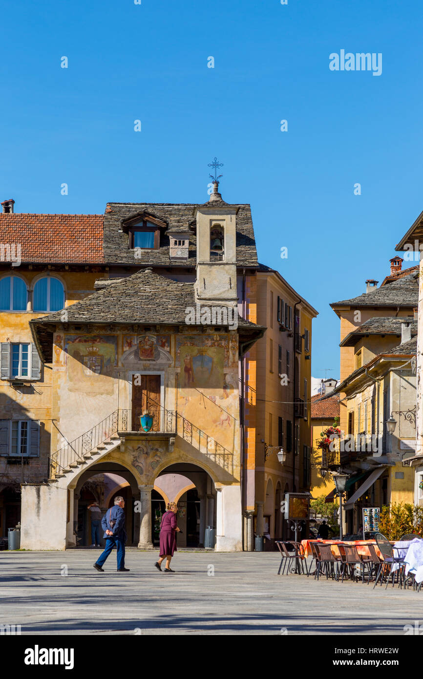 Two person walking through  Motta square at Orta San Giulio village, Lake Orta, Novara, Piedmont, Italy Europe Stock Photo