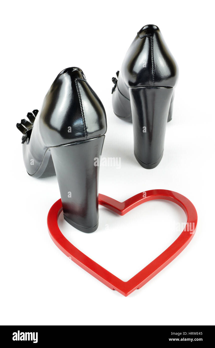 Black elegant leather high heel loafer shoes and heart figure on white Stock Photo