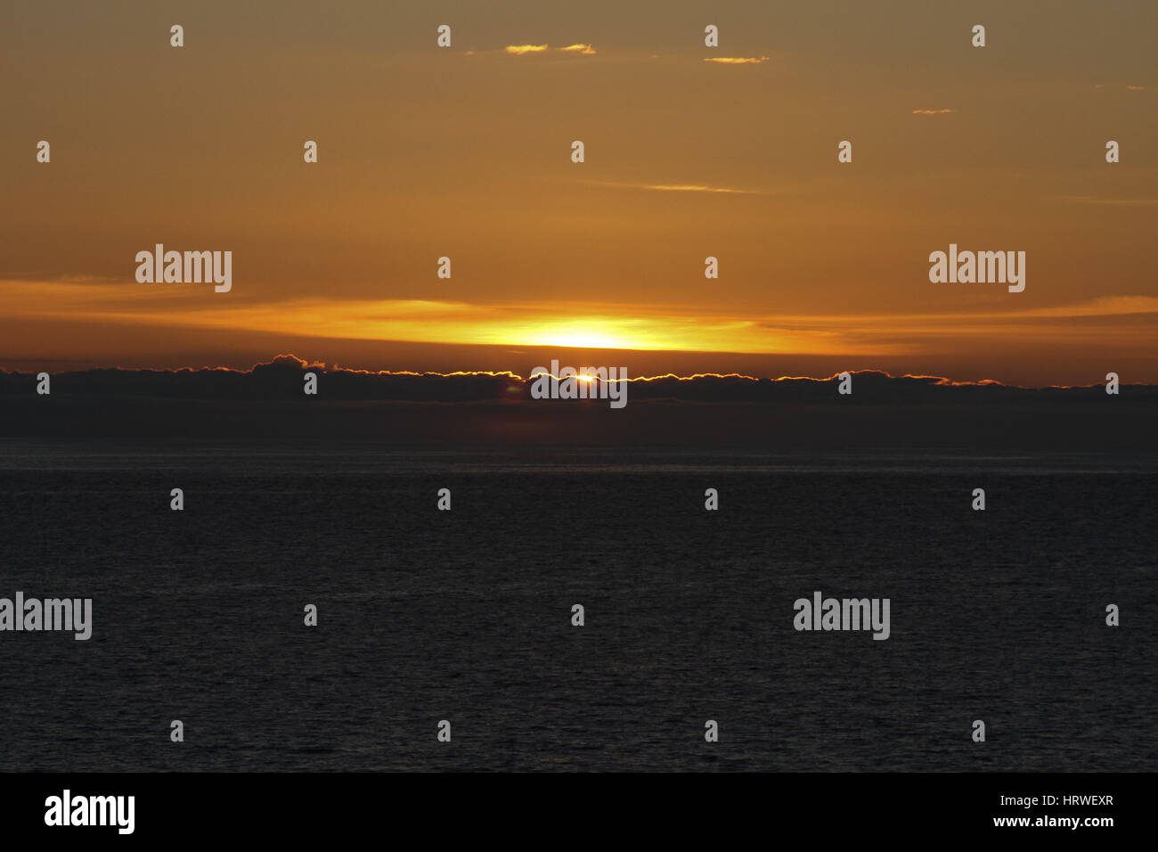 Golden clouds during the sunset over the sea Stock Photo - Alamy