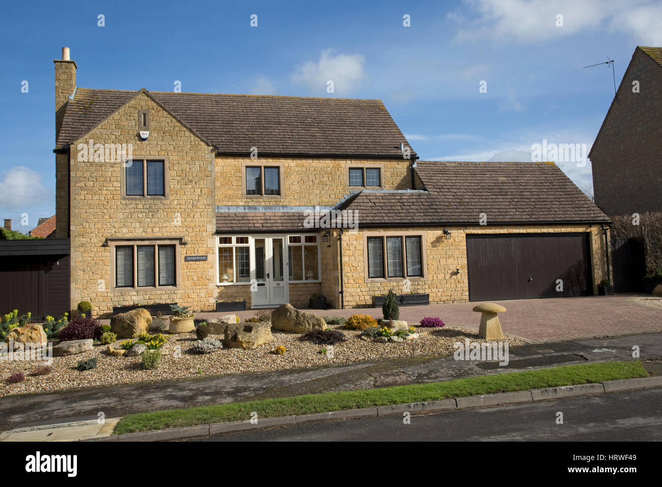 Large detached Cotswold stone substantial family houses double garage landscaped gardens Mickleton UK Stock Photo