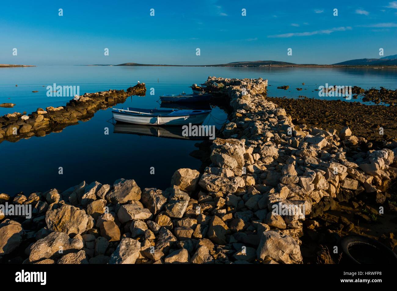 Small stone harbor on Pag island in Croatia near Povljana Stock Photo