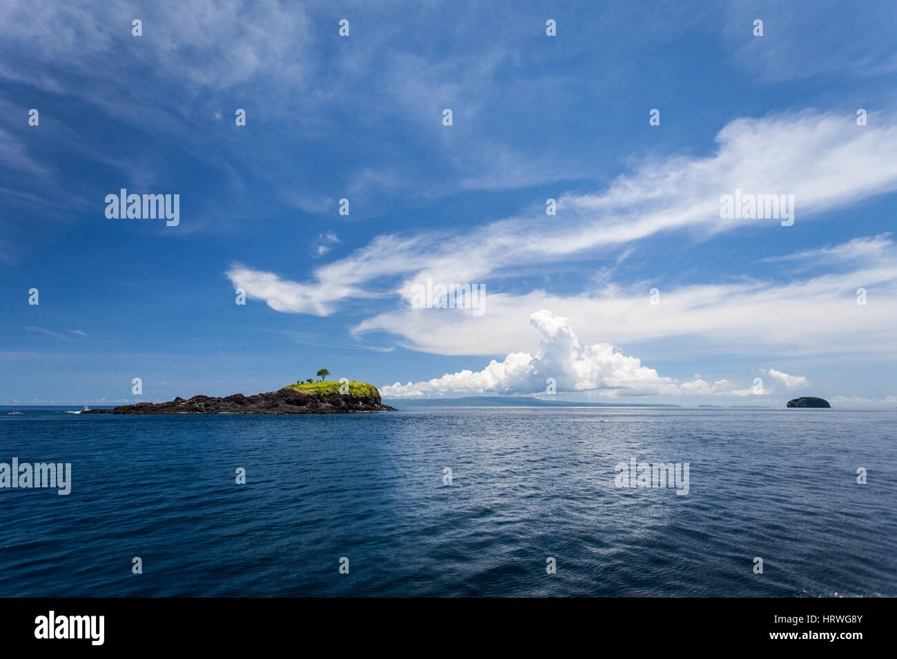 Seascape with small island looks like a whale and a Dolphin on the background of Nusa Penida, Indonesia Stock Photo
