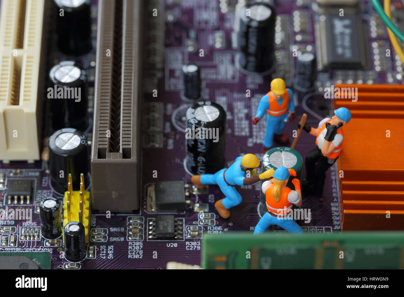 Selective focus of miniature engineer and worker fixed and  mainboard computer and use for business background. Stock Photo