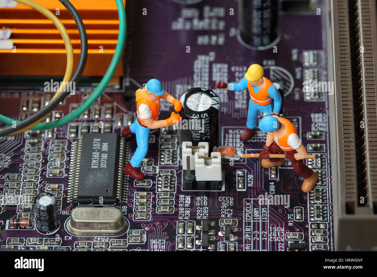 Selective focus of miniature engineer and worker fixed and maintenance mainboard computer and use for business background. Stock Photo