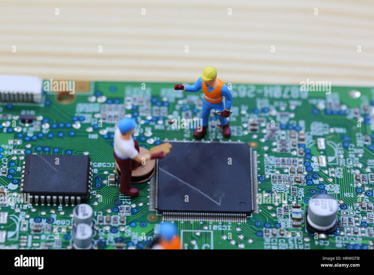 Selective focus of miniature engineer and worker fixed chip of  mainboard computer and use for business background. Stock Photo