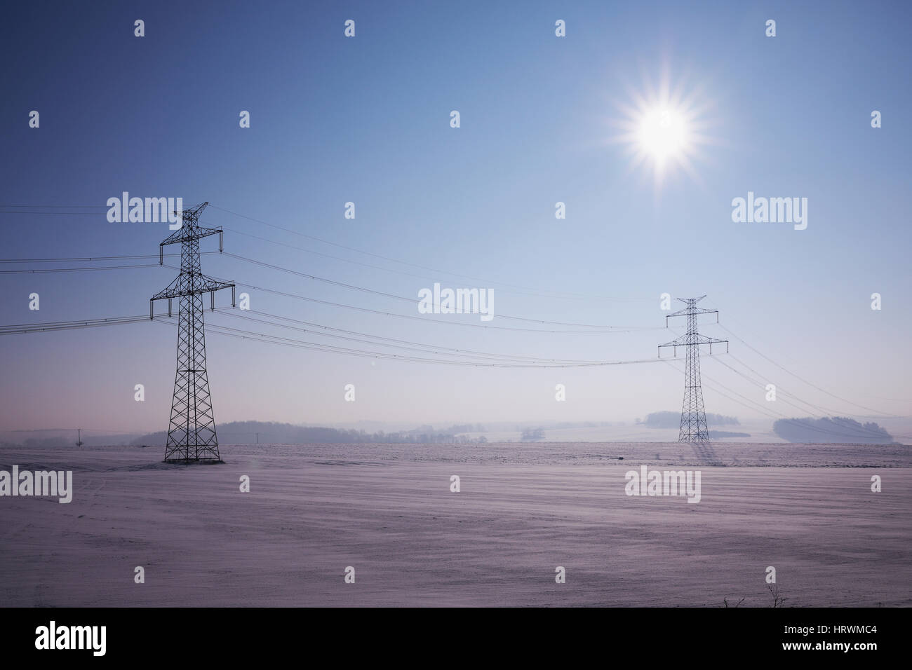 high voltage pylons in winter on a sunny day Stock Photo - Alamy
