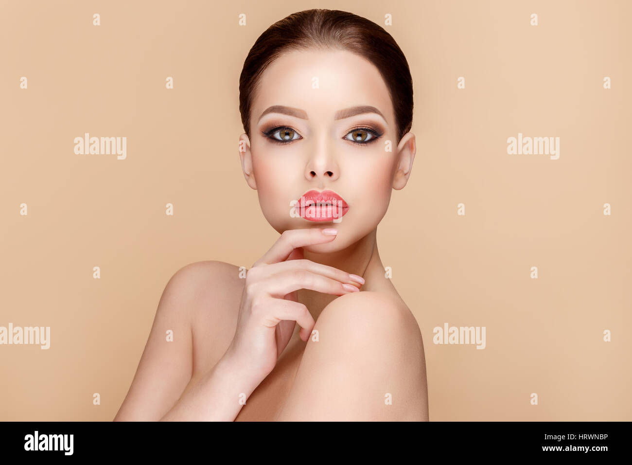 Beautiful Face of Young Woman with Clean Fresh Skin close up on beige ...
