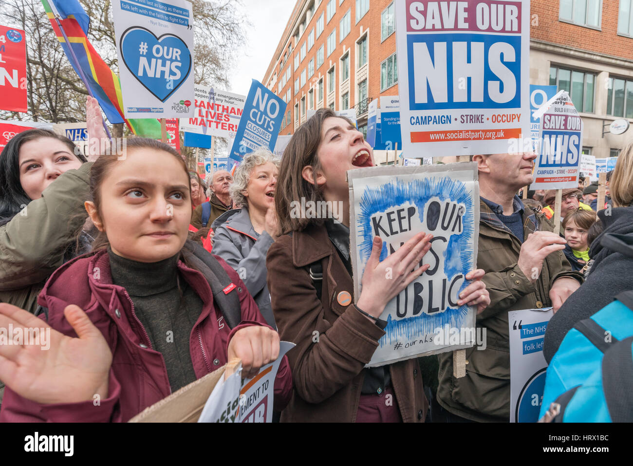 London, UK. 4th March 2017. The crowd responds to a speaker at the rally before thousands march though London from Tavistock Square where the BMA have their headquarters to a rally in Parliament Square in protest against the cuts and privatisation of the NHS which they say is at breaking point. At the rally before the march, local councils who had turned down the Sustainability and Transformation Plans for hospital closures and cuts in services were loudly cheered and others were urged to follow their example. Credit: Peter Marshall/Alamy Live News Stock Photo