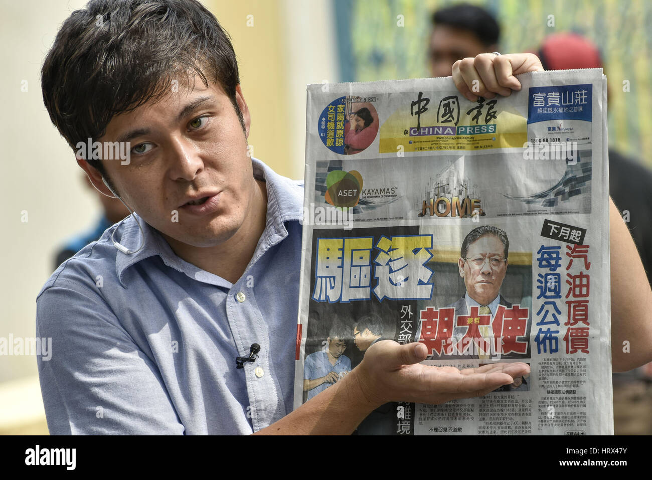 Kuala Lumpur, MALAYSIA. 5th Mar, 2017. Japanese Nippon TV reporter holds local newspaper China Press with handles a news report at outside of the North Korea Embassy on March 05, 2017 at Kuala Lumpur, Malaysia. North Korean Ambassador Kang Chol has accused Malaysia of colluding with foreign powers in the murder of Kim Jong-nam, must leave the country within 48 hours. Credit: Chris Jung/ZUMA Wire/Alamy Live News Stock Photo