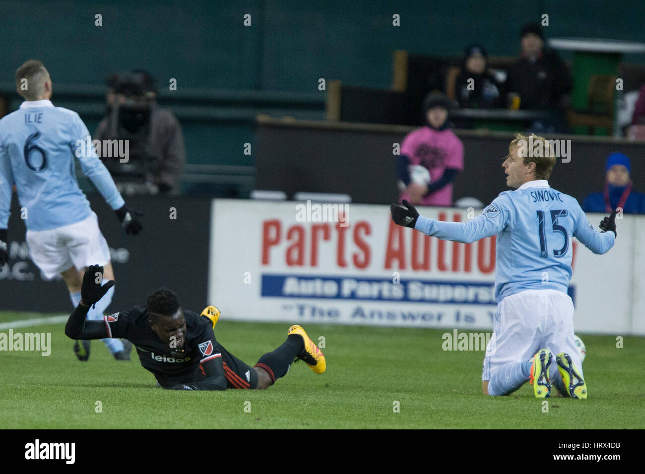 Washington, DC, USA. 04th Mar, 2017. D.C. United forward Patrick Nyarko (12) and Sporting Kansas City defender Seth Sinovic (15) react after a contentious tackle by Nyarko which resulted in a penalty at RFK Stadium in Washington, DC on Saturday March 4, 2 Stock Photo