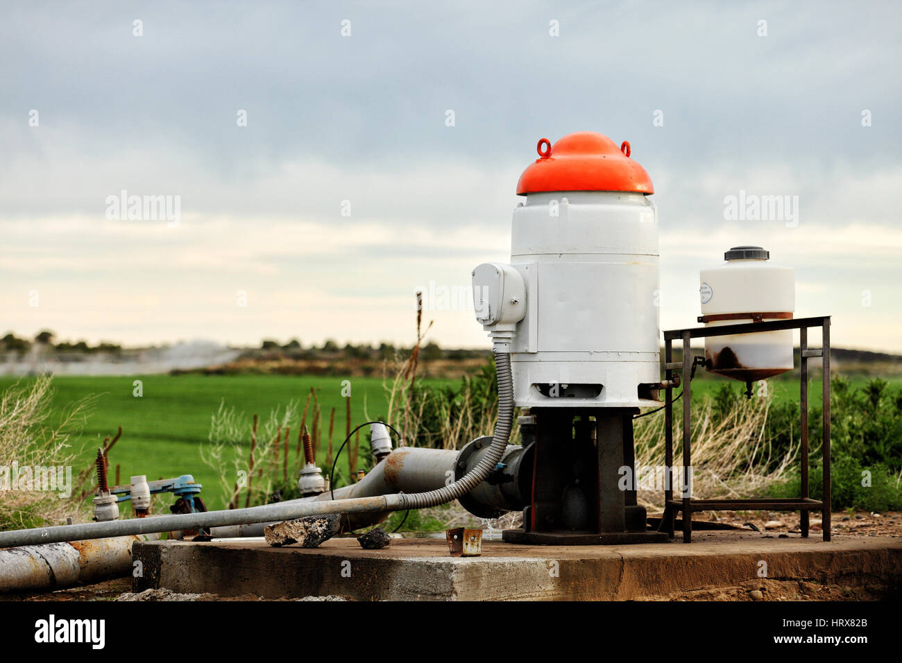 The pumping station where water is pumped from a ground well, and distributed to irrigation sprinklers in farm fields. Stock Photo