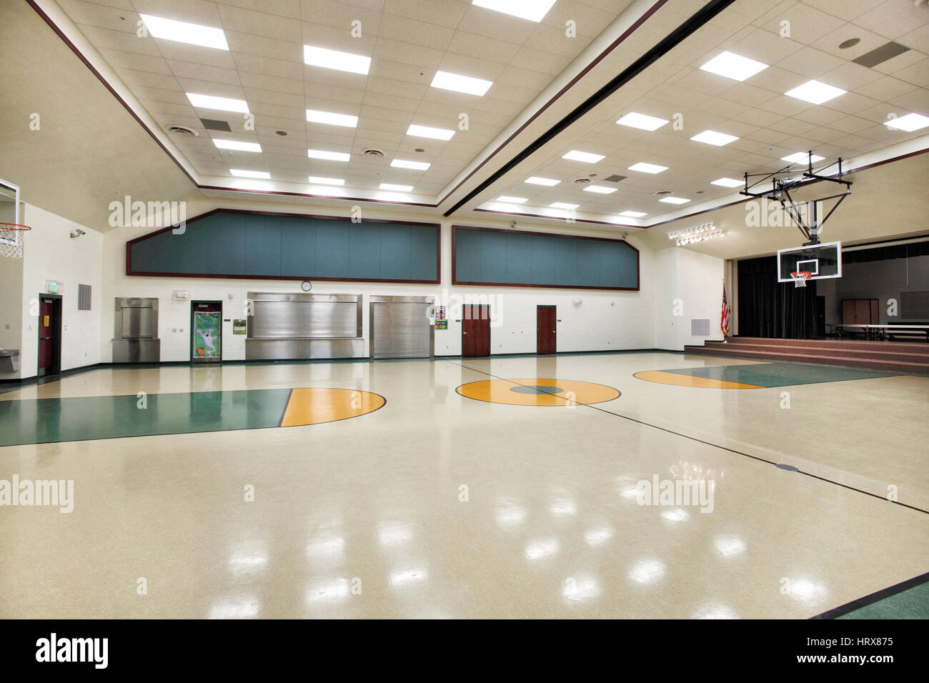 The multipurpose room in a modern elementary school, which functions as a gym, lunchroom, meeting room, and theater. Stock Photo