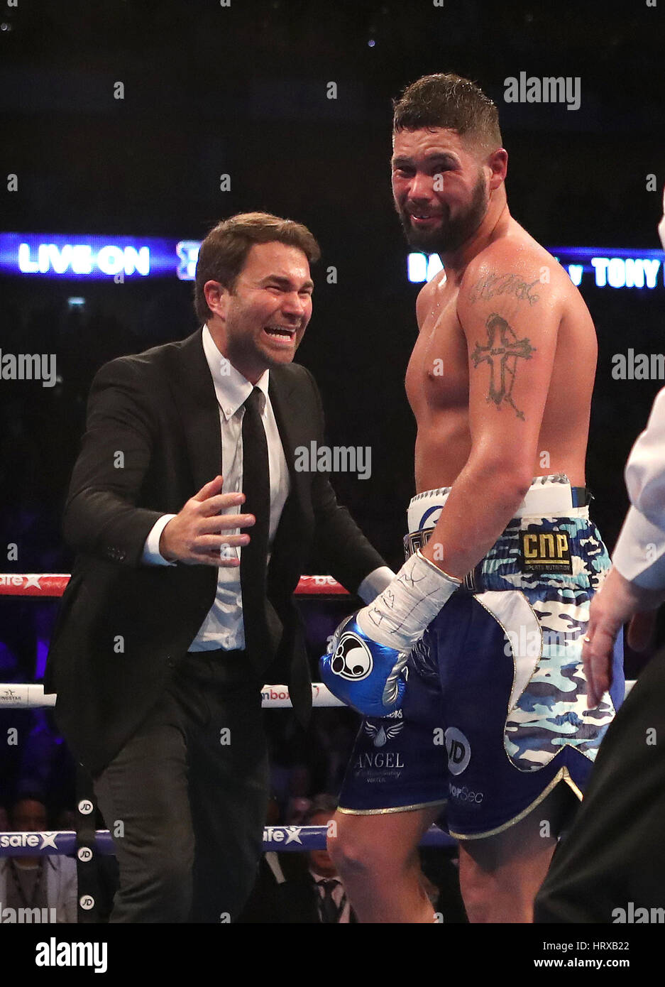 Tony Bellew celebrates his victory over David Haye with promoter Eddie Hearn during the heavyweight contest at The O2. Stock Photo