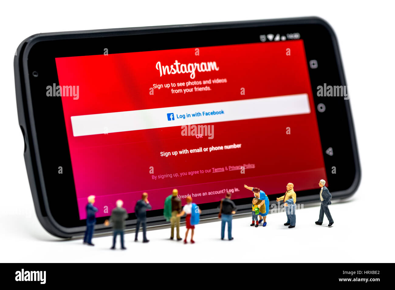 LIMASSOL, CYPRUS - DECEMBER 07, 2015: Group of people watching at Instagram application sign in page on smartphone. Social networking concept on Decem Stock Photo
