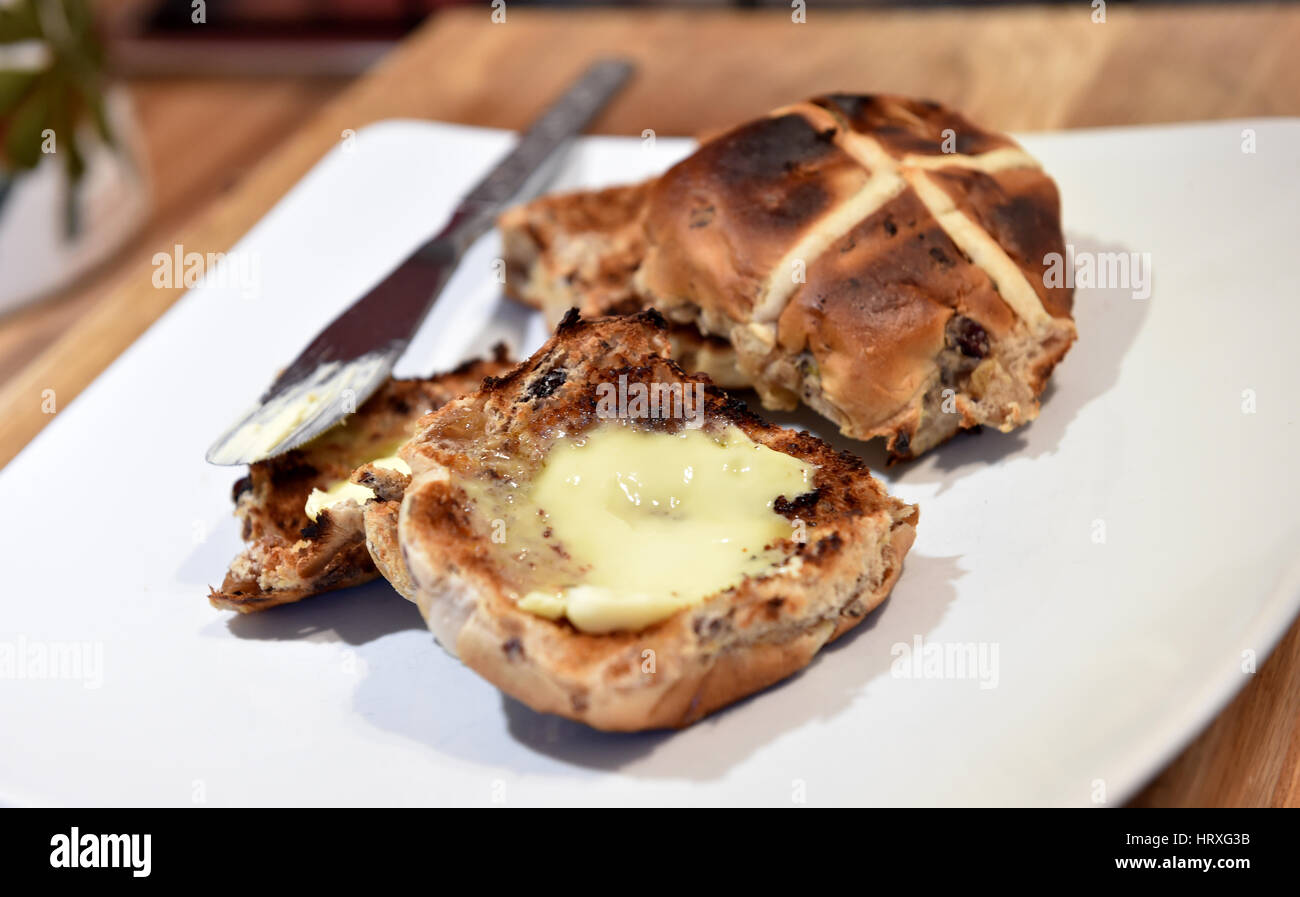 Toasted hot cross buns with butter for Easter Good Friday celebrations in UK Stock Photo Alamy