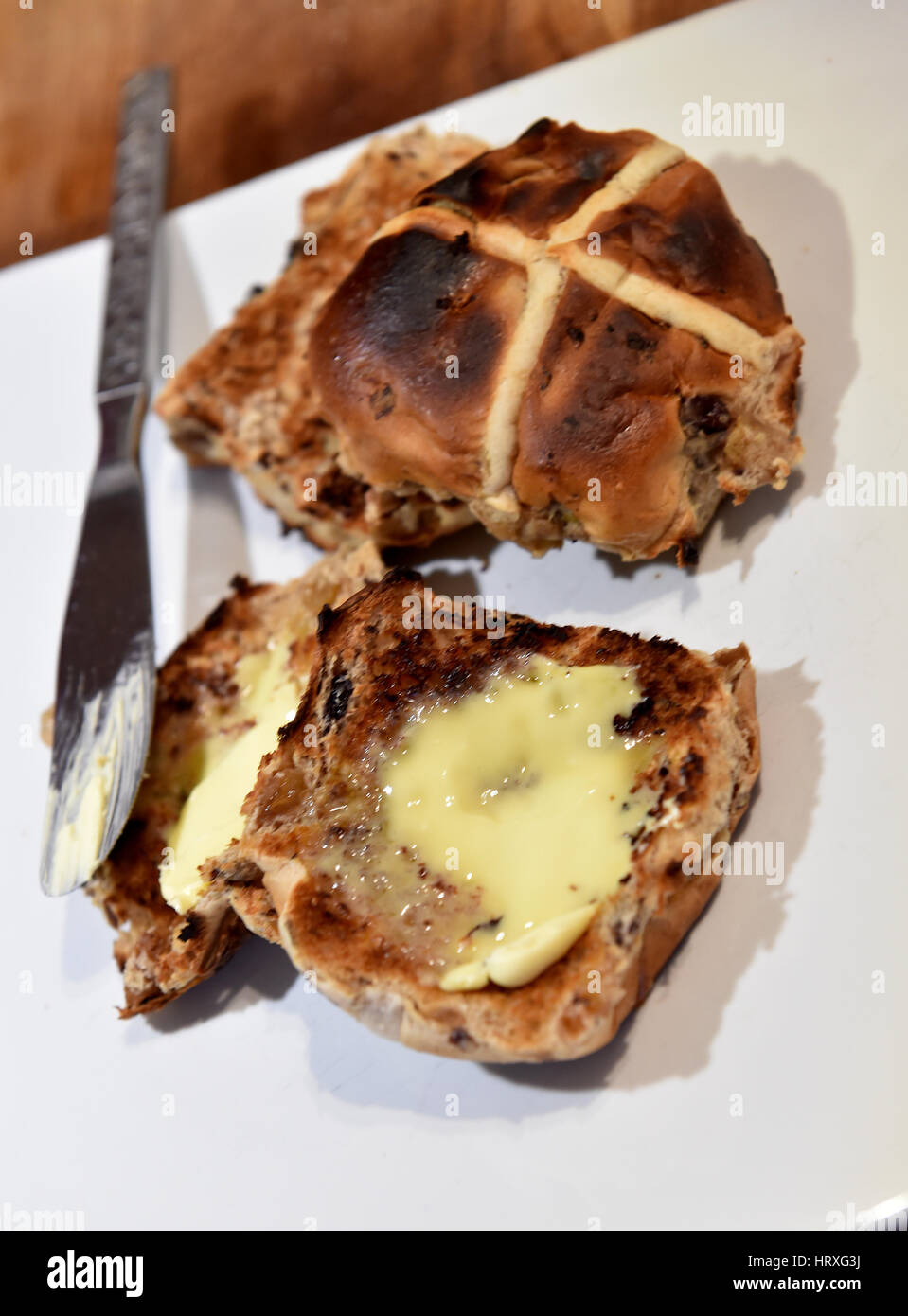 Toasted hot cross buns with butter for Easter Good Friday celebrations in UK Stock Photo Alamy