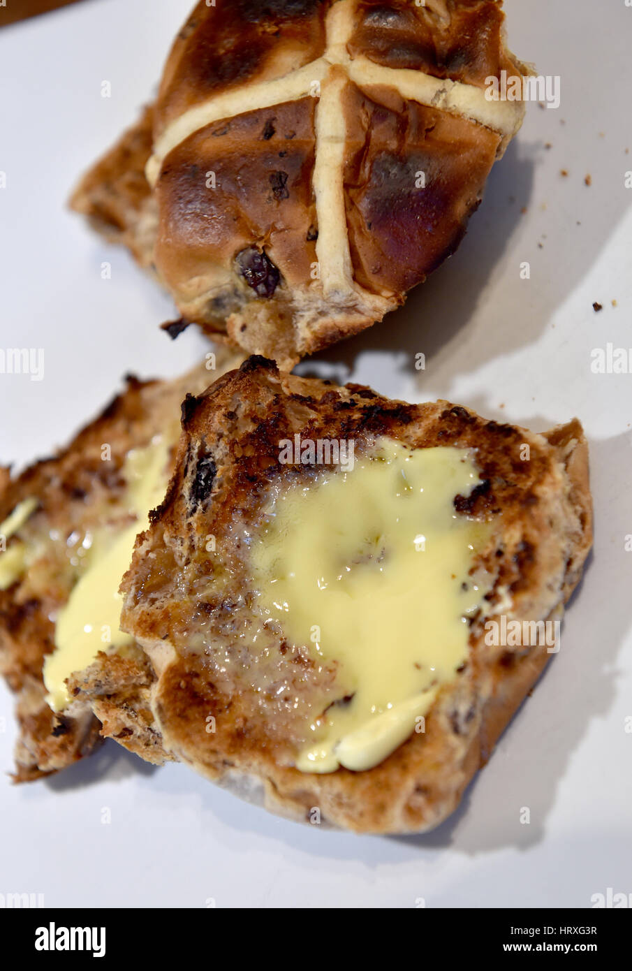 Toasted hot cross buns with butter for Easter Good Friday celebrations in UK Stock Photo Alamy