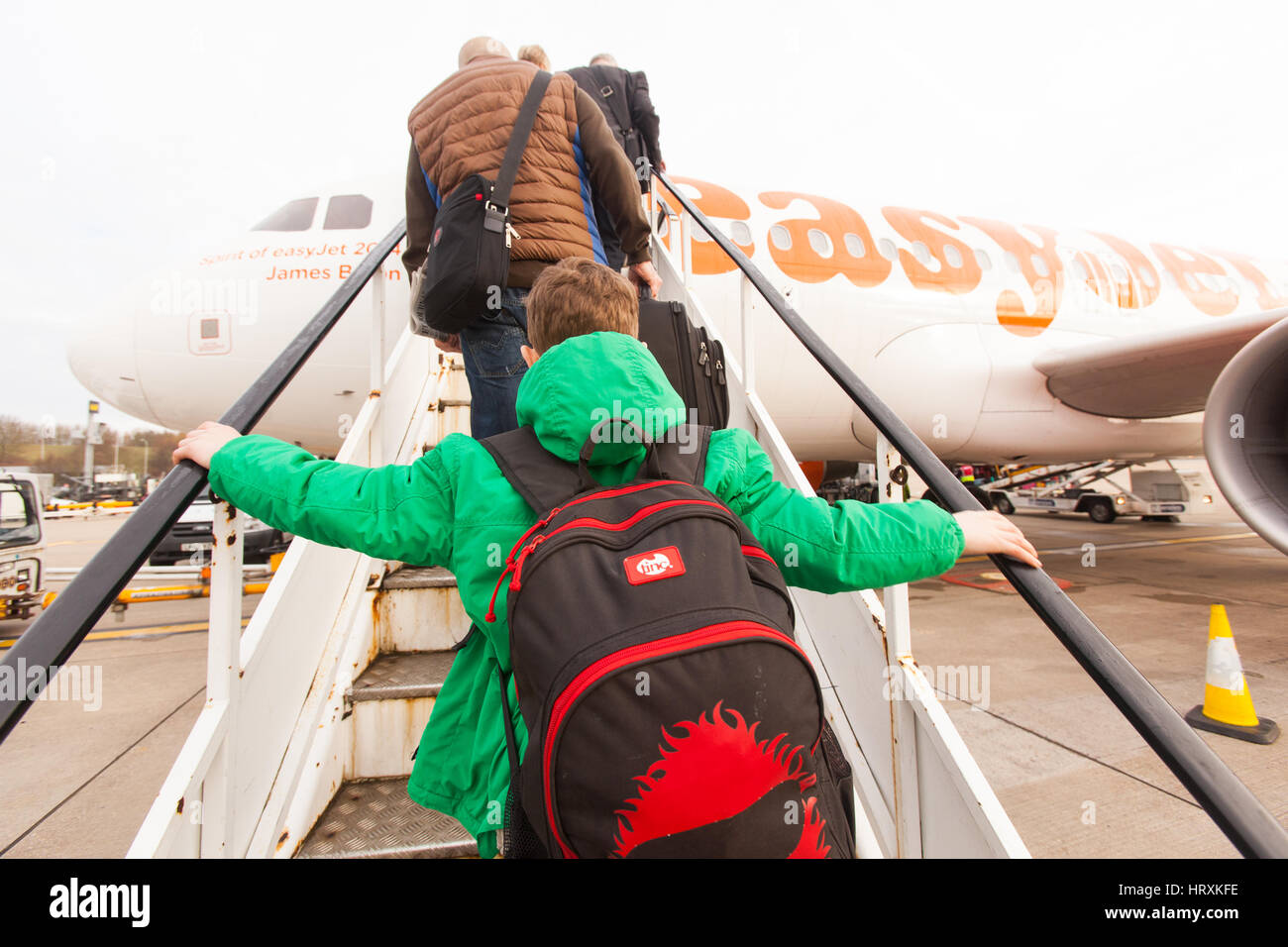 Seven year old boy excitedly boarding a Easyjet flight at London Gatwick airport. Stock Photo