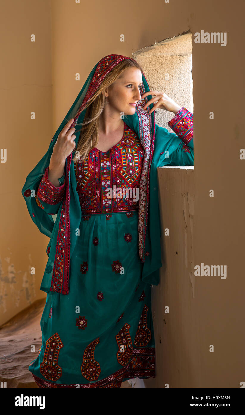 A woman in traditional omani dress in an abondoned village in a desert Stock Photo Alamy