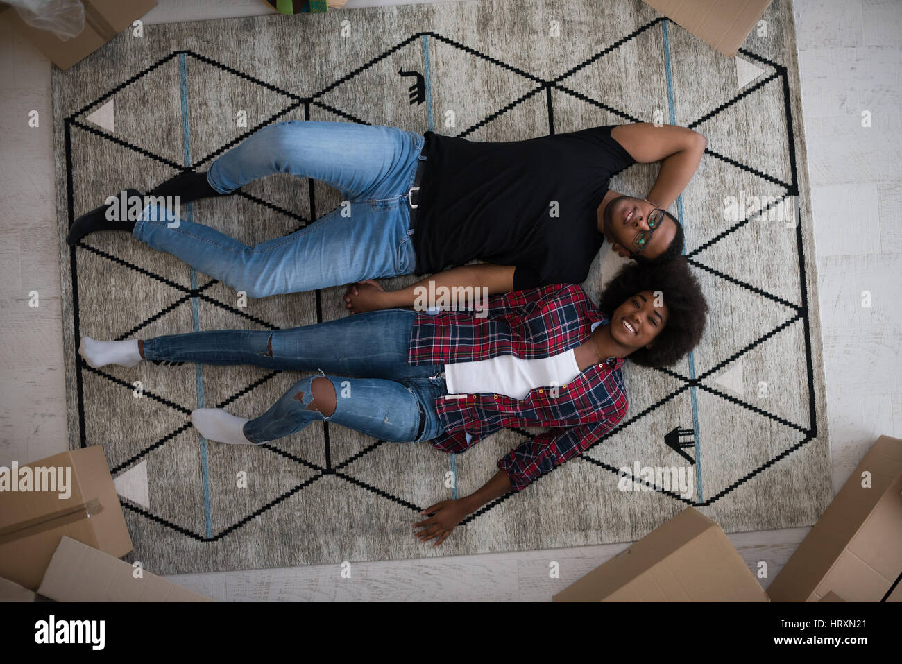 Top view of attractive young African American couple moving, holding ...