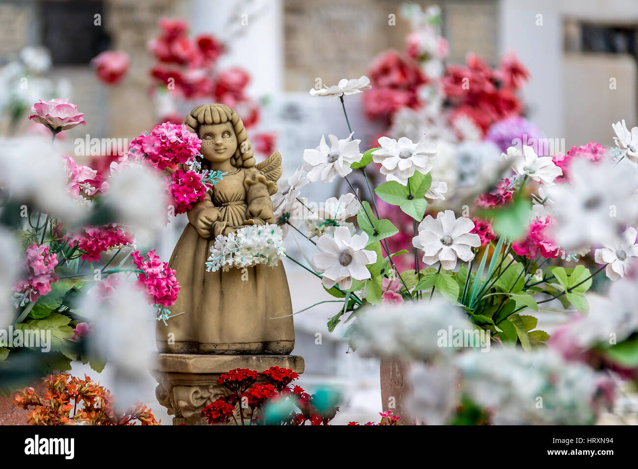 Cute angel girl statue and flowers Stock Photo