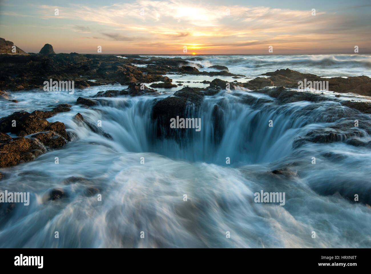 Thor's Well is actually a hole in the rock that only appears to drain water from the ocean. Stock Photo
