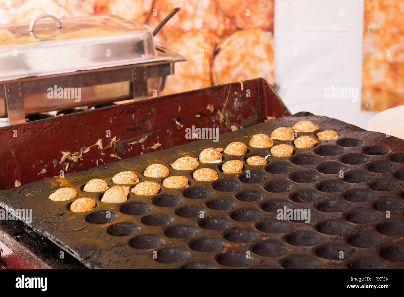 Poffertjes being cooked and sold in a roadside stall in Amsterdam, The Netherlands Stock Photo