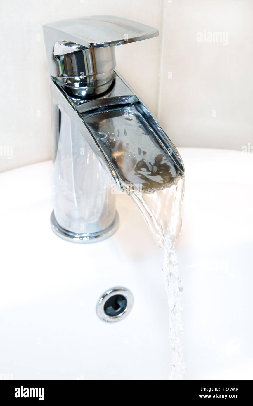 Modern style chrome waterfall tap or faucet Stock Photo