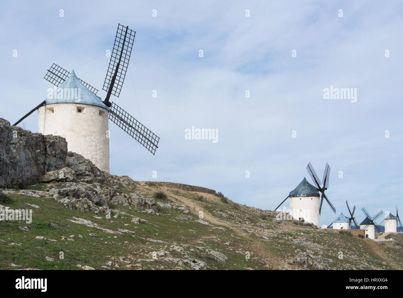 White old windmills on the hill near Consuegra (Castilla La Mancha, Spain), a symbol of region and journeys of Don Quixote (Alonso Quijano) on cloudy  Stock Photo