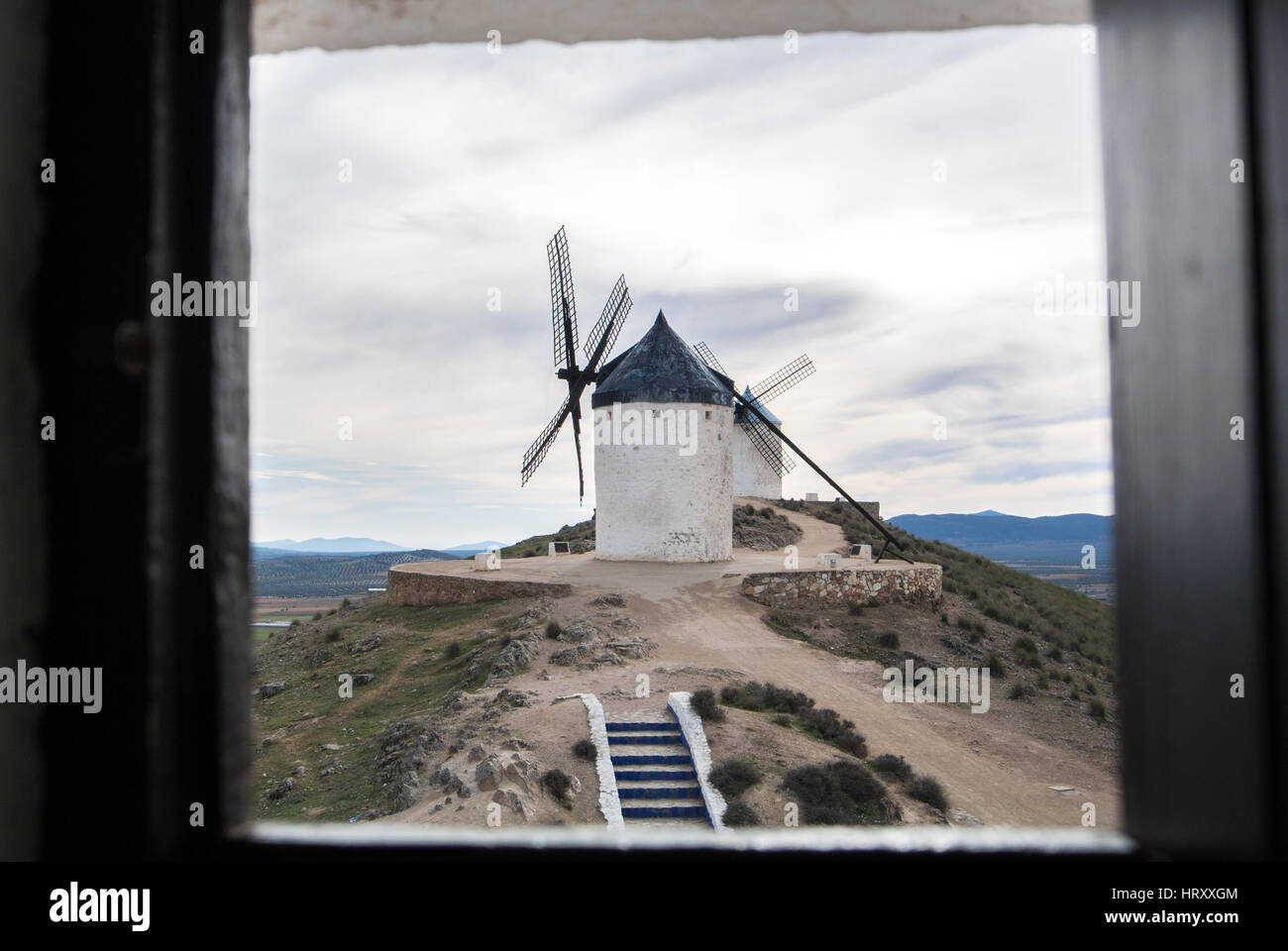White old windmill on the hill near Consuegra (Castilla La Mancha, Spain), a symbol of region and journeys of Don Quixote (Alonso Quijano) and a town  Stock Photo