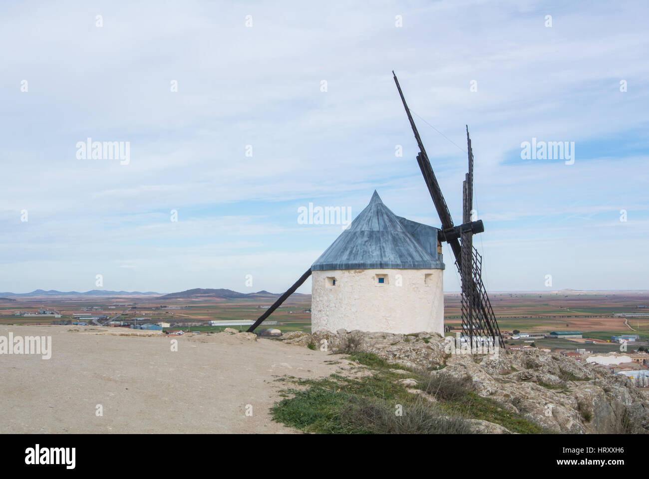 White old windmill on the hill near Consuegra (Castilla La Mancha, Spain), a symbol of region and journeys of Don Quixote (Alonso Quijano) and a town  Stock Photo