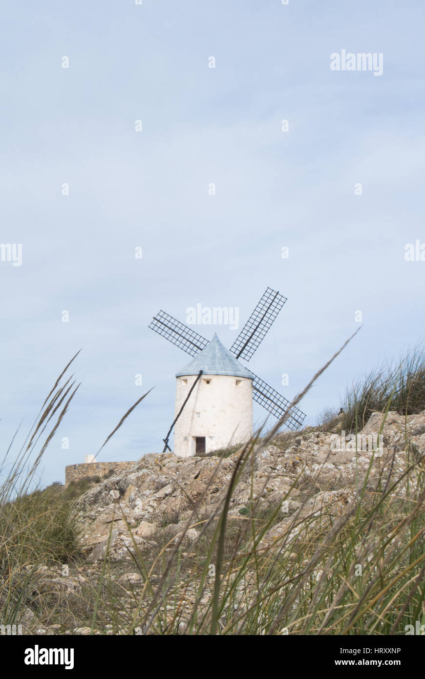 White old windmill on the hill near Consuegra (Castilla La Mancha, Spain), a symbol of region and journeys of Don Quixote (Alonso Quijano) on cloudy d Stock Photo