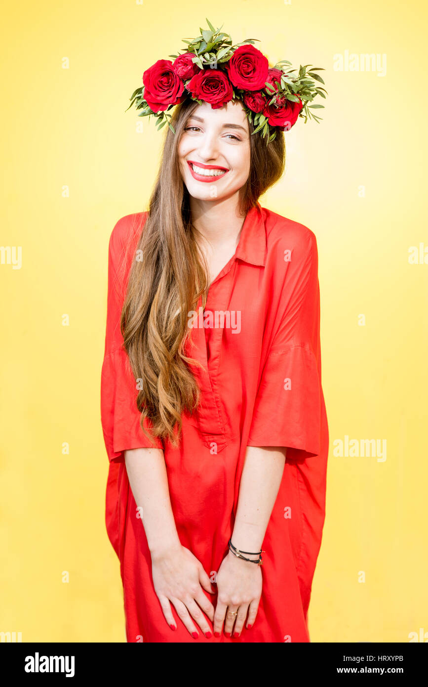 Colorful portrait of a beautiful woman in red dress with wreath made of ...
