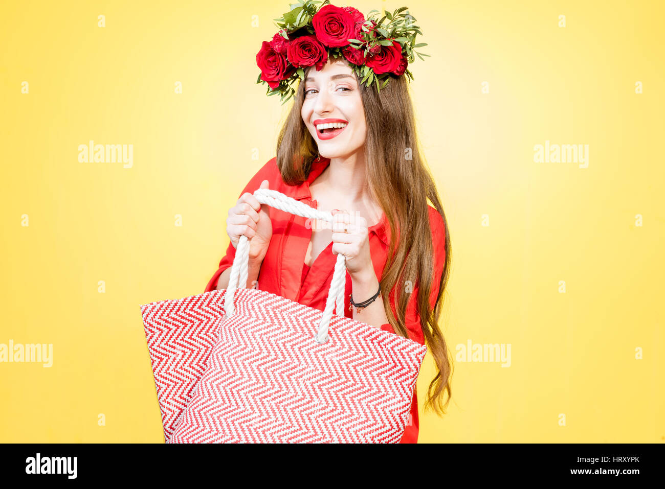 Colorful portrait of a beautiful woman in red dress with wreath made of ...