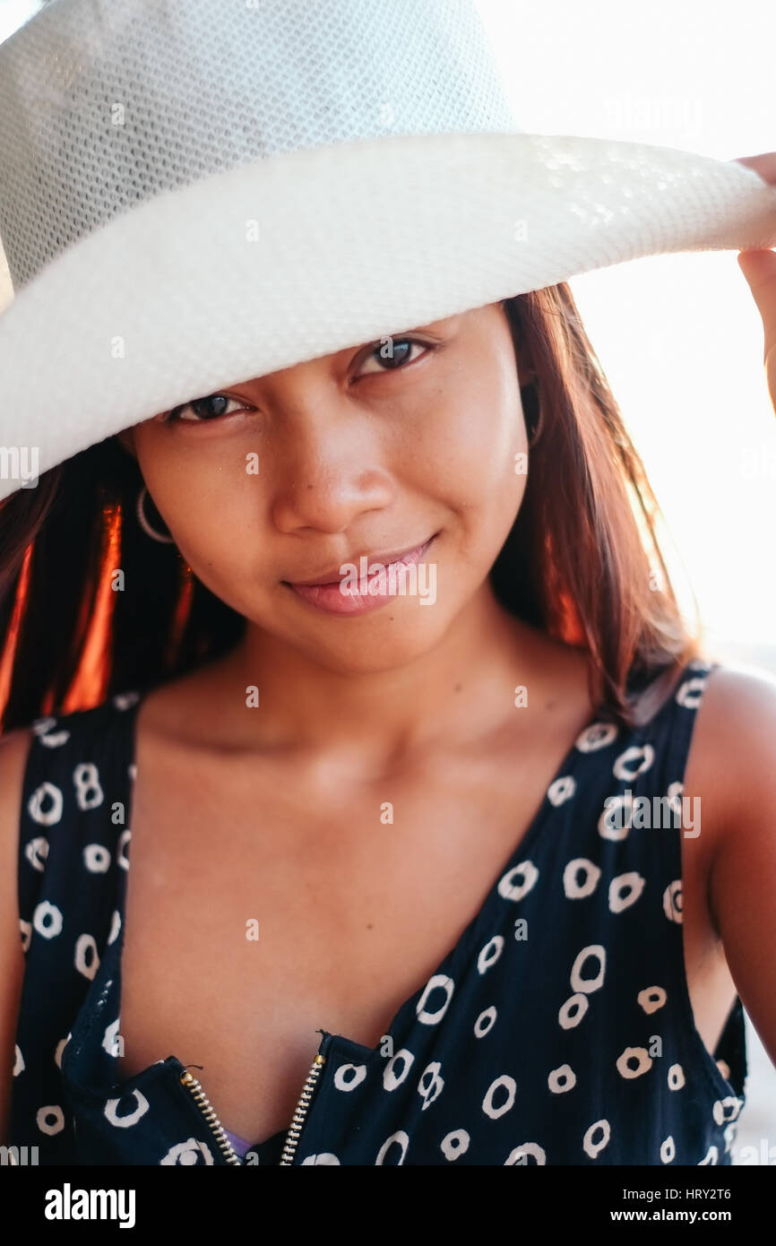 Portrait of beautiful young Asian girl with hat on summer Stock Photo