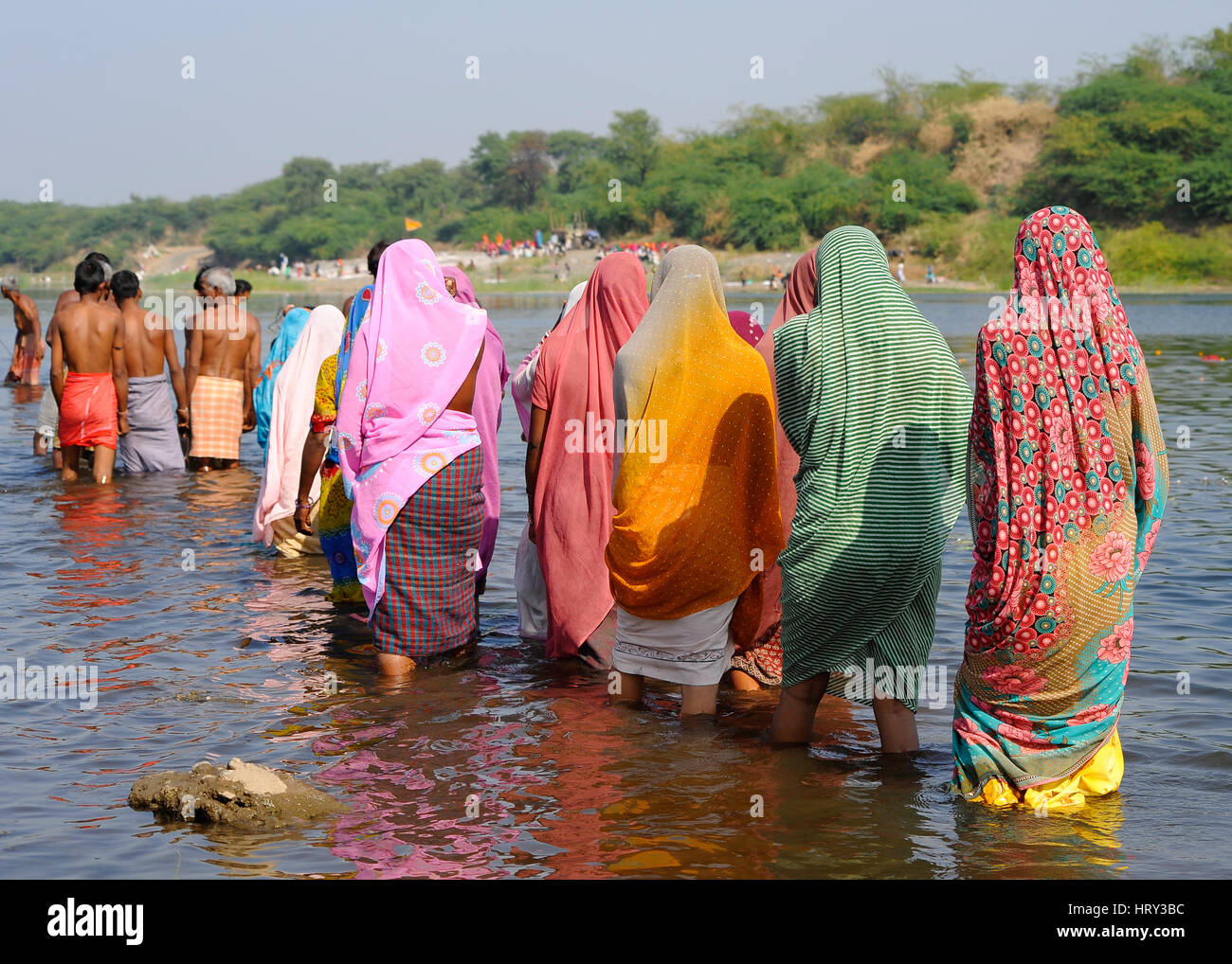 Bhil people gather in the waters during Baneshwar Mela Stock Photo