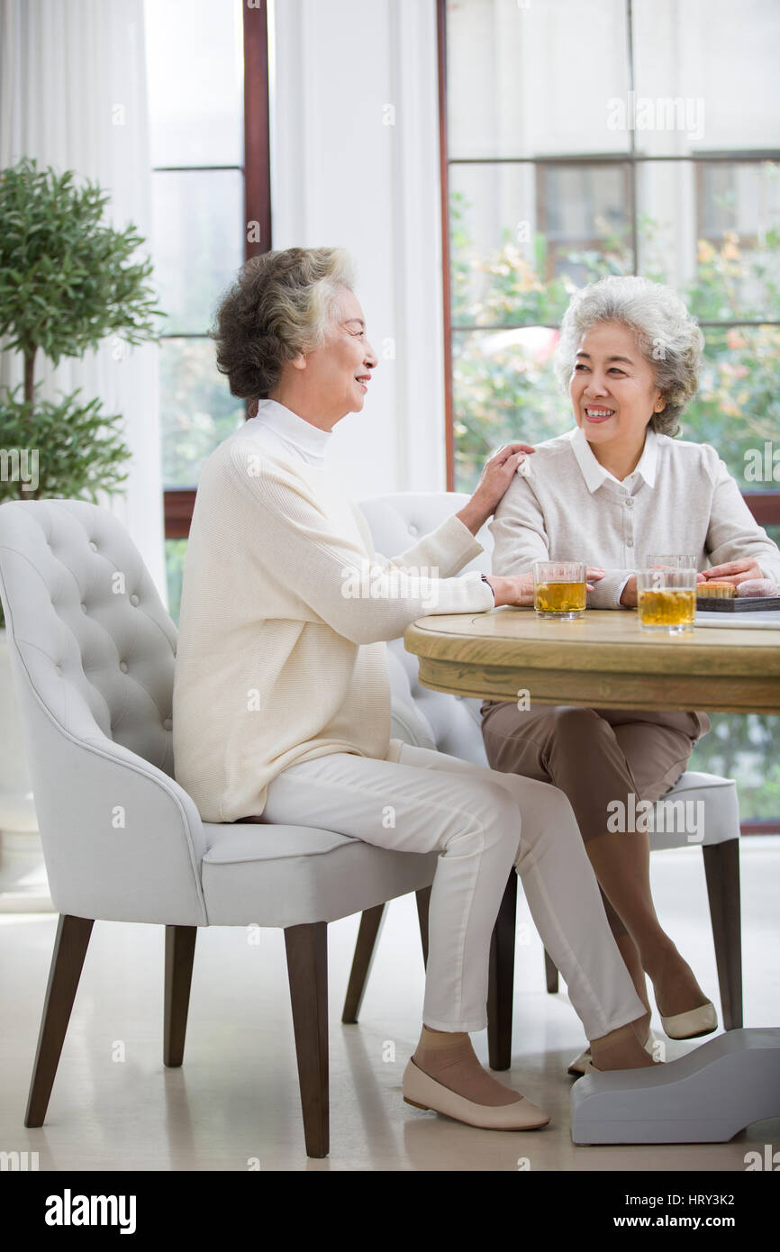 Happy senior women talking and drinking tea Stock Photo - Alamy