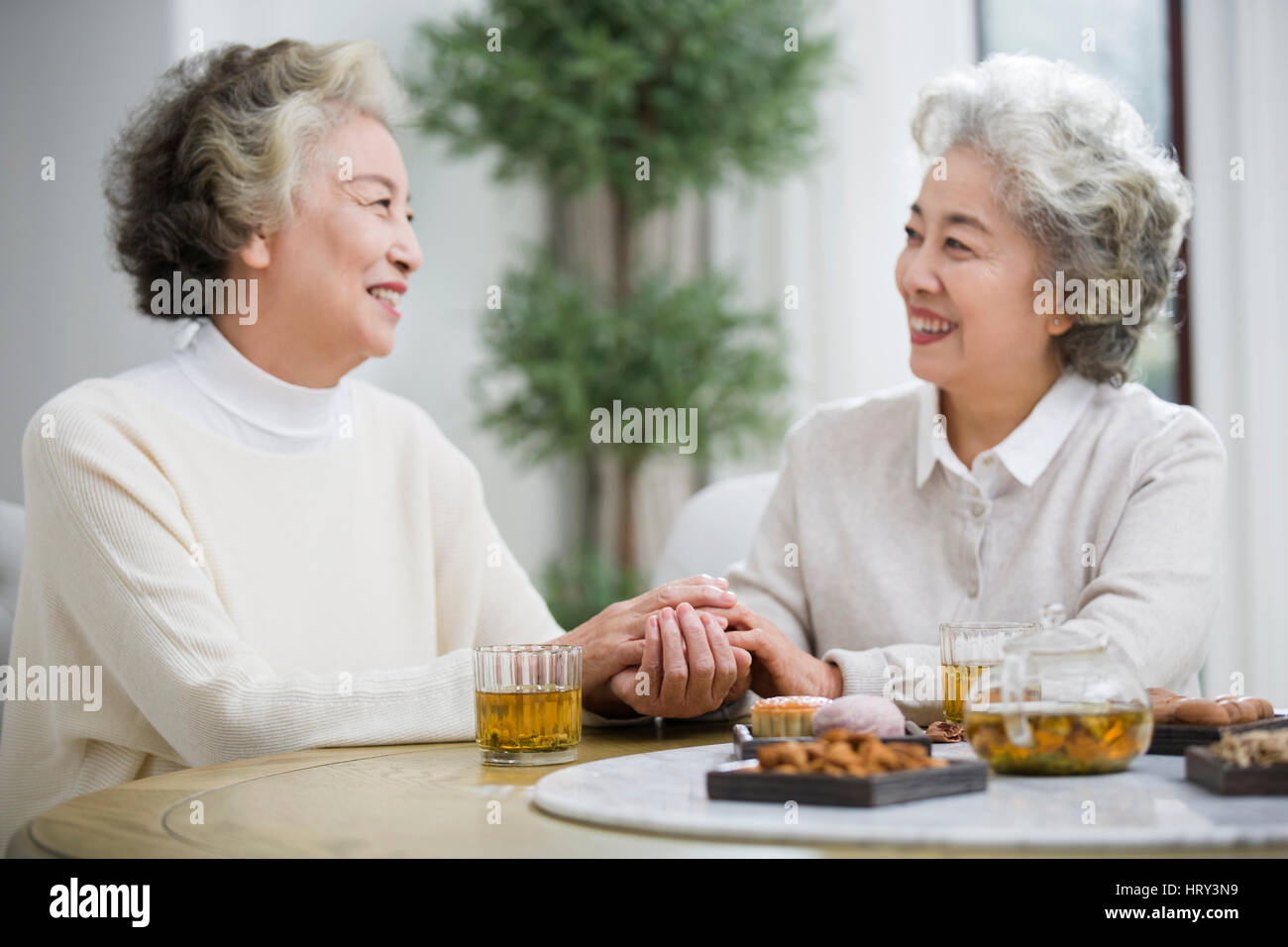 Happy senior women talking and drinking tea Stock Photo - Alamy