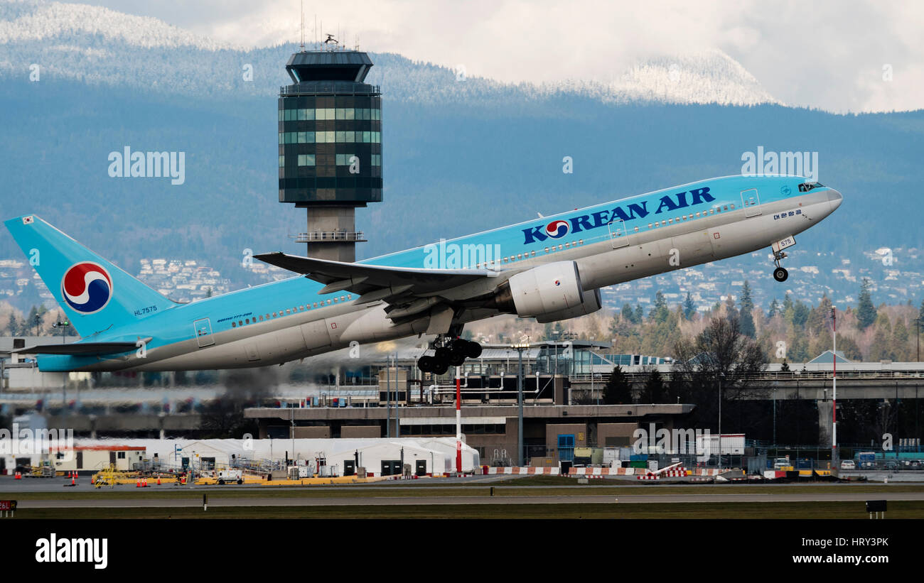 Korean Air Airlines plane airplane Boeing 777 (777-200ER) take taking off Vancouver International Airport airport control tower terminal scene Stock Photo