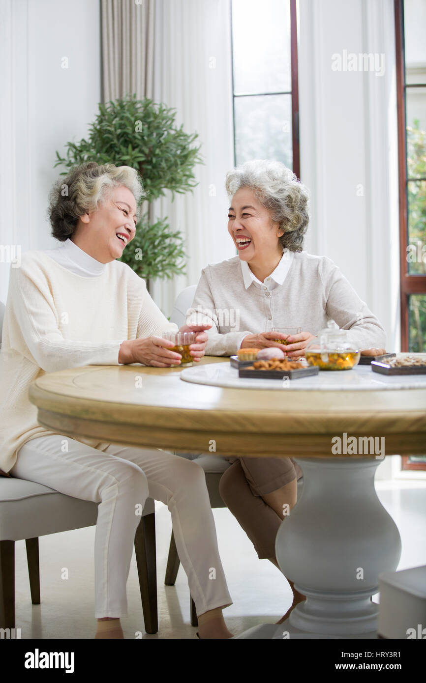 Happy senior women talking and drinking tea Stock Photo - Alamy