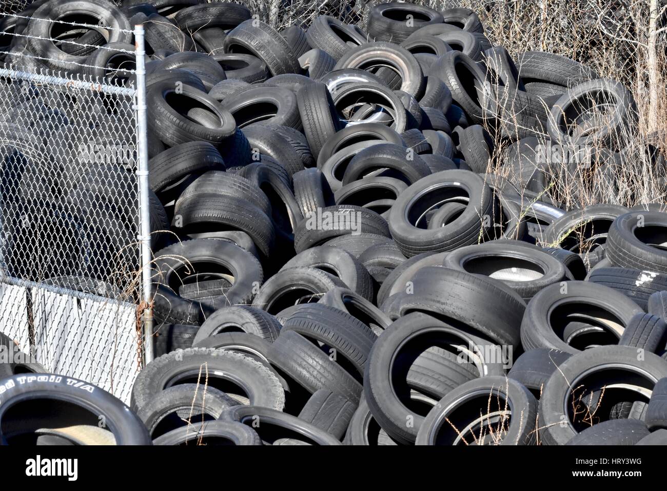 Pile of used tires in a junk yard Stock Photo